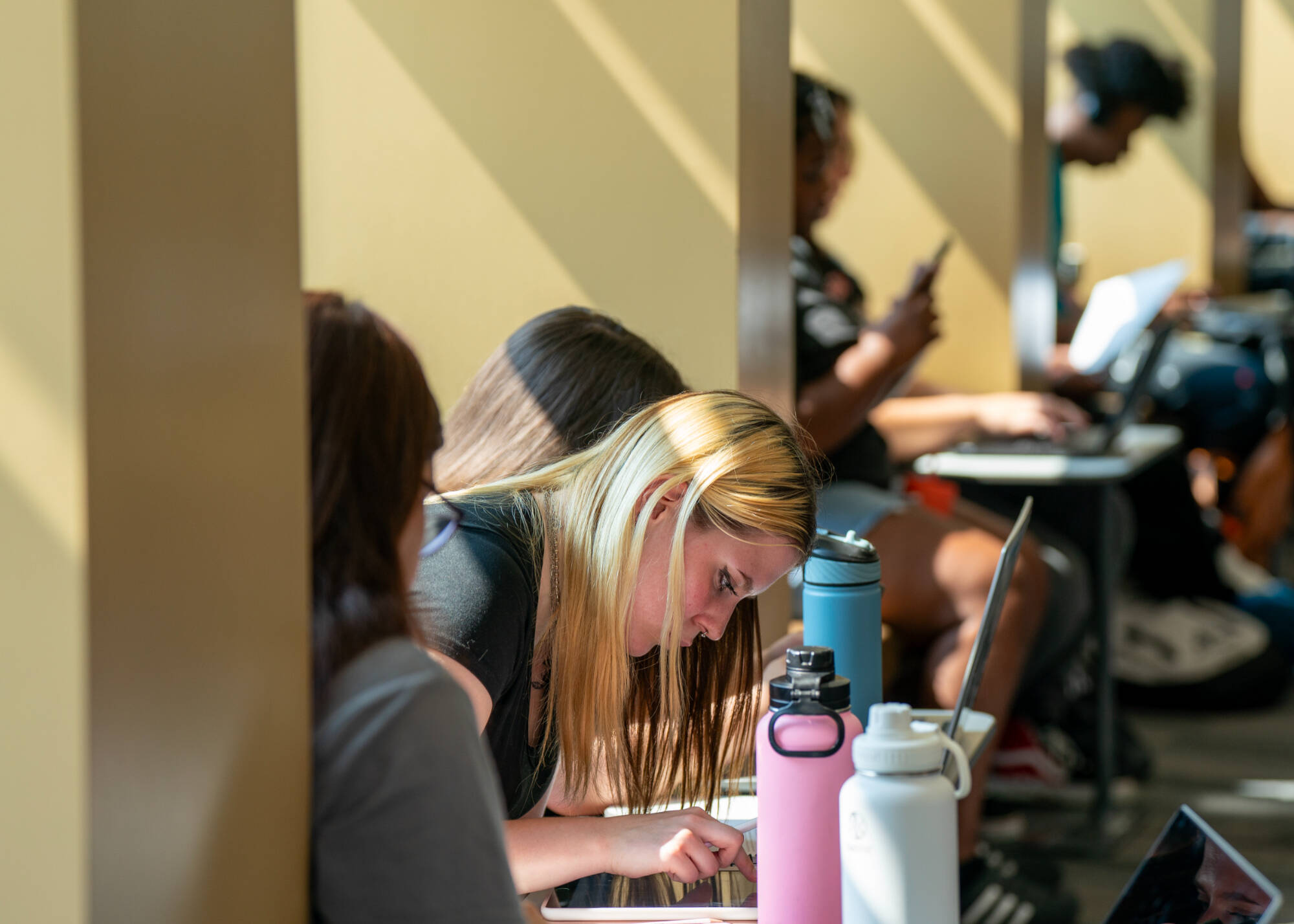 GVSU art education student Lillian Welling, center, studies as part of the Oliver Wilson Scholars program at the Holton-Hooker Learning and Living Center on July 22.